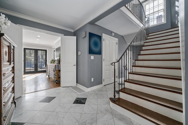 foyer entrance featuring stairs, french doors, baseboards, and crown molding