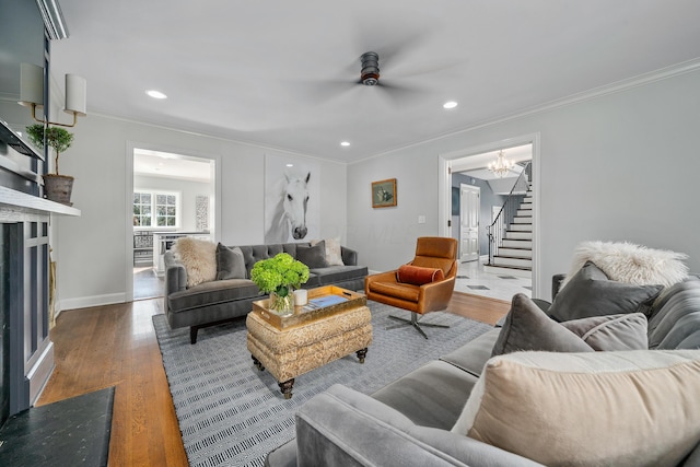 living area featuring crown molding, stairs, dark wood-style flooring, and recessed lighting