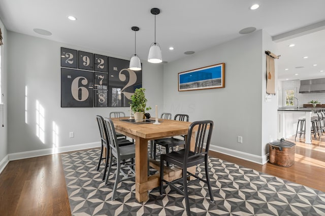 dining room with recessed lighting, dark wood finished floors, and baseboards