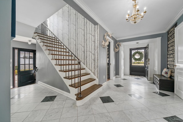 foyer featuring baseboards, an accent wall, stairway, crown molding, and a chandelier