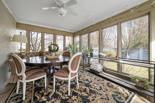 sunroom / solarium featuring ceiling fan