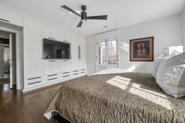 bedroom with visible vents, dark wood finished floors, and ceiling fan