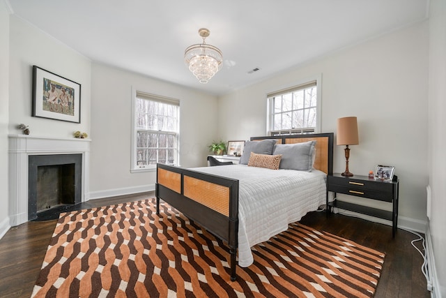 bedroom with dark wood-style flooring, multiple windows, and baseboards