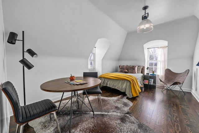 bedroom with dark wood-style flooring, vaulted ceiling, and baseboards