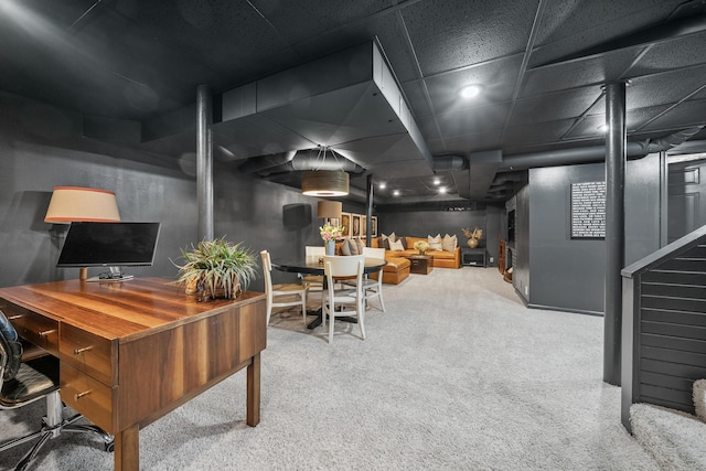 office space with light carpet and a paneled ceiling