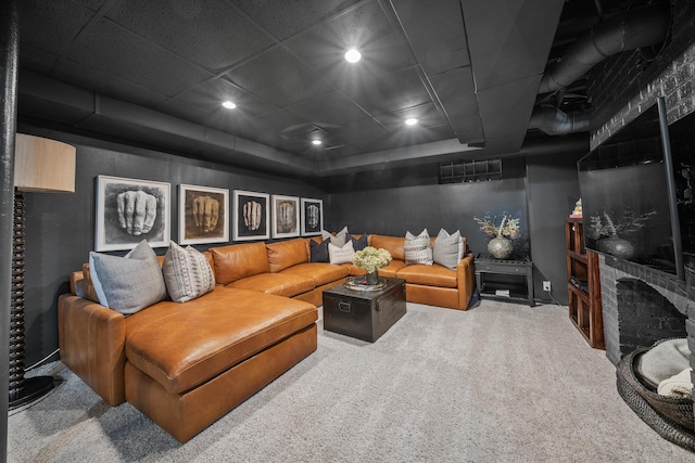 home theater room with carpet, a brick fireplace, visible vents, and recessed lighting