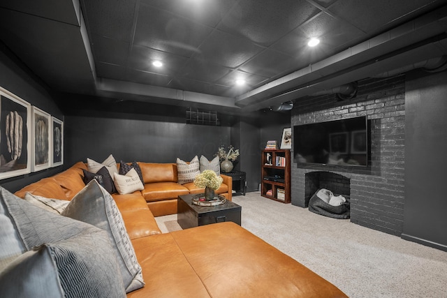 carpeted living area featuring a brick fireplace