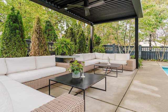 view of patio with ceiling fan, fence, and an outdoor living space