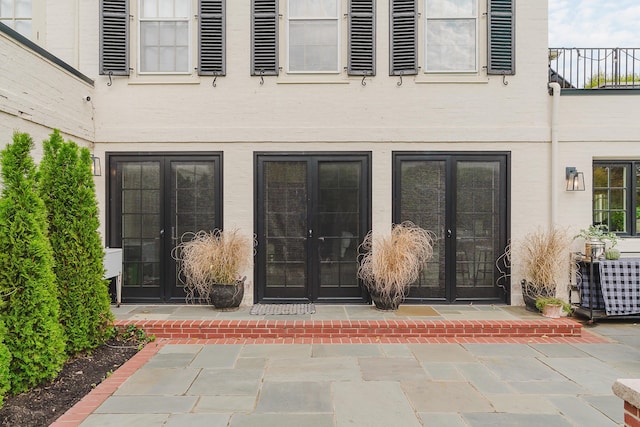 property entrance with a patio and french doors