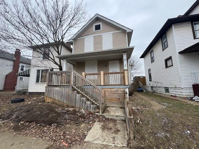 view of front facade with covered porch and stairway