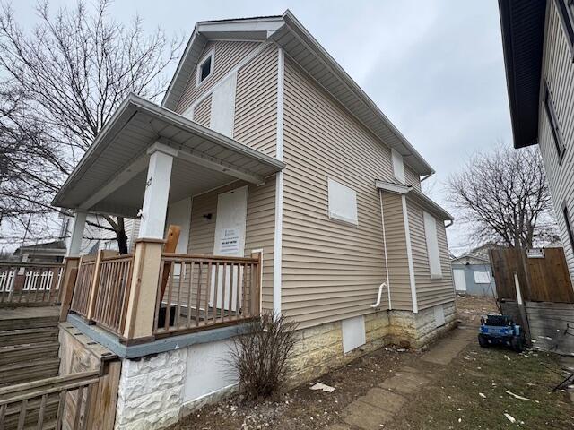 view of side of home featuring a porch