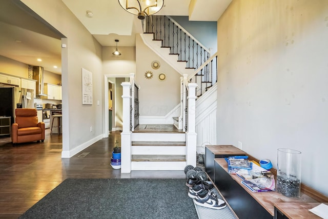 stairway featuring wood finished floors and baseboards