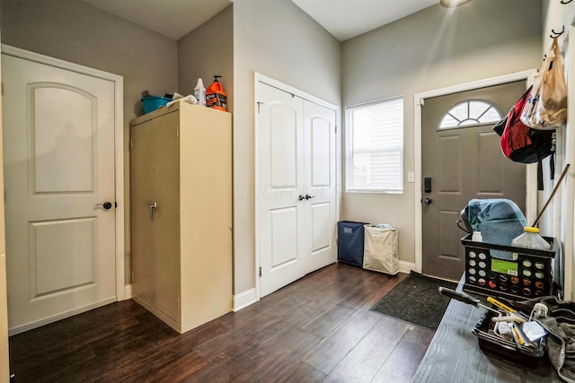 entryway featuring dark wood finished floors and baseboards