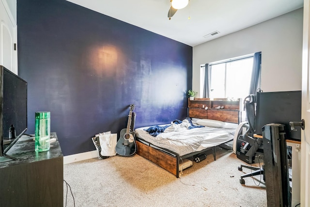 carpeted bedroom featuring visible vents, ceiling fan, and baseboards