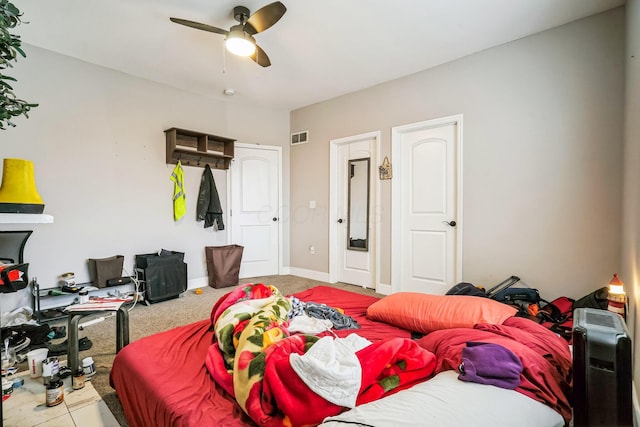 bedroom featuring light colored carpet, visible vents, ceiling fan, and baseboards