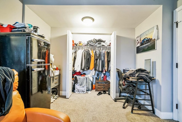 spacious closet featuring light colored carpet