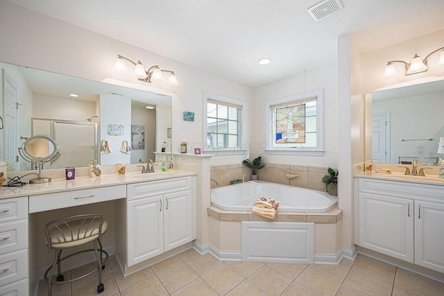 full bath with a stall shower, tile patterned flooring, visible vents, and a sink