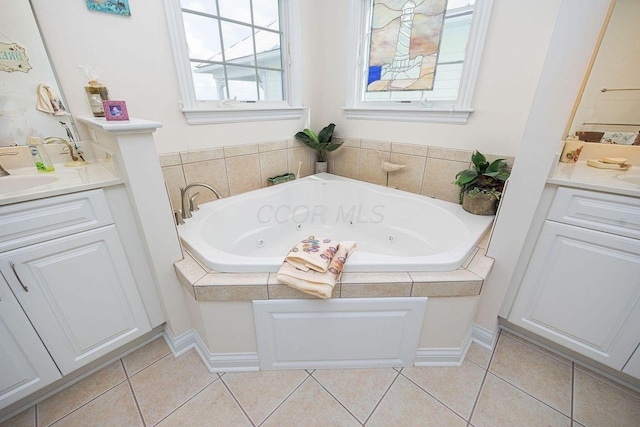 full bathroom with a tub with jets, tile patterned flooring, and vanity