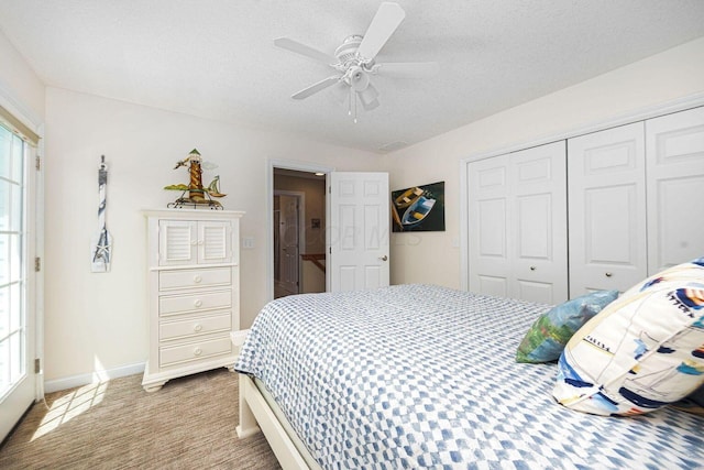 bedroom with a textured ceiling, multiple windows, and a closet