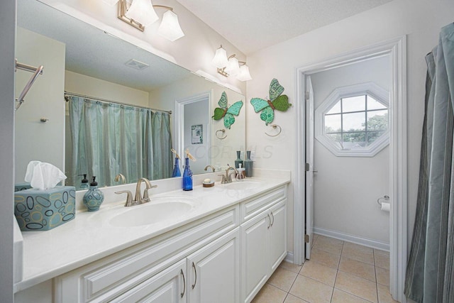 full bath with tile patterned flooring, visible vents, a sink, and double vanity