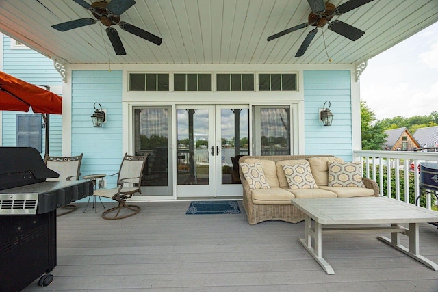 wooden deck with ceiling fan, an outdoor hangout area, and french doors