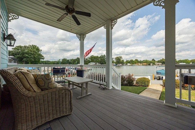 deck featuring a water view and ceiling fan