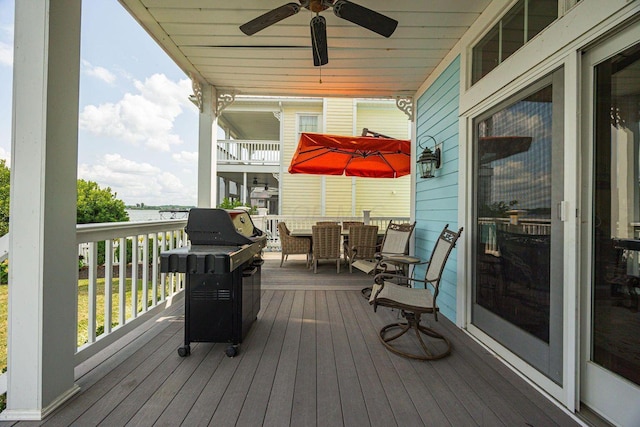 deck with a ceiling fan, outdoor dining space, and grilling area