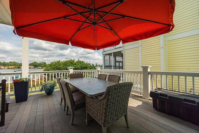 deck with a sunroom and outdoor dining space