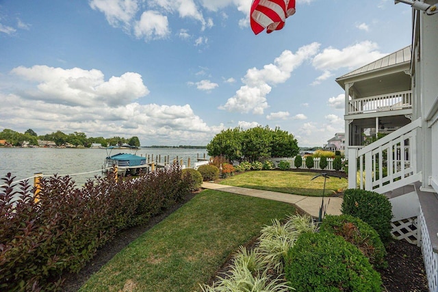 view of yard with a water view and a boat dock