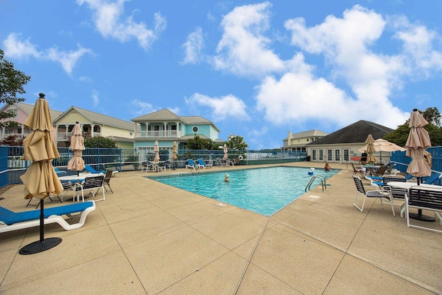 pool with fence and a patio