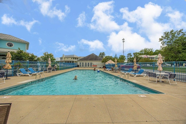 pool featuring a patio area and fence