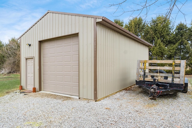 detached garage with gravel driveway