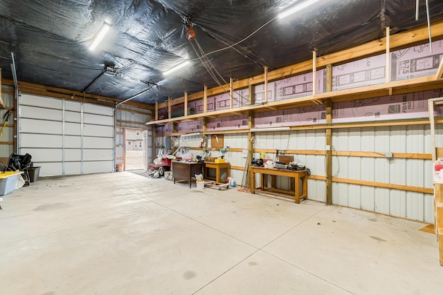 garage with metal wall and a garage door opener