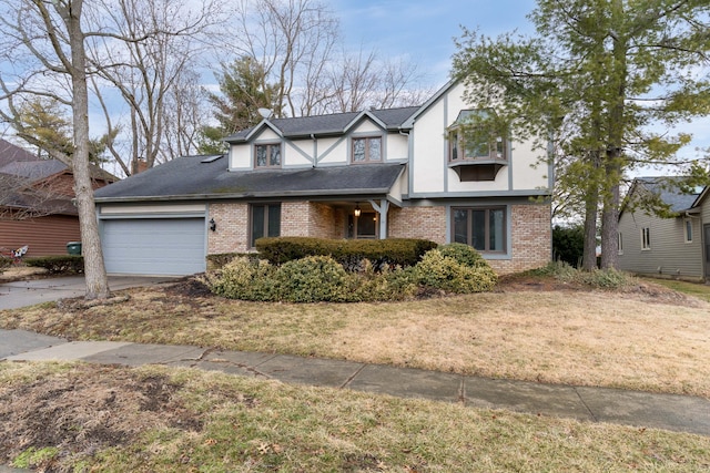 tudor-style house featuring brick siding, roof with shingles, an attached garage, driveway, and a front lawn