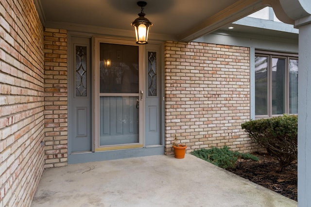 property entrance featuring brick siding