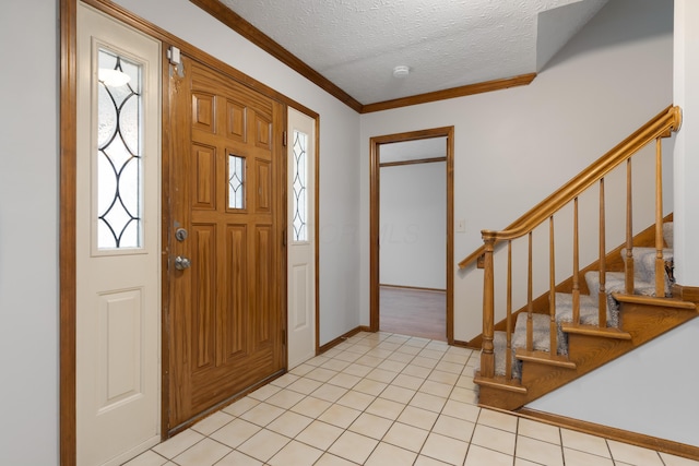 foyer featuring crown molding, stairway, light tile patterned flooring, a textured ceiling, and baseboards