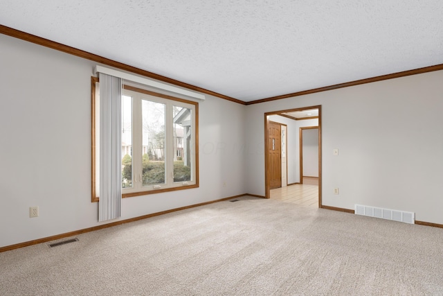 unfurnished room featuring light colored carpet, visible vents, crown molding, and a textured ceiling