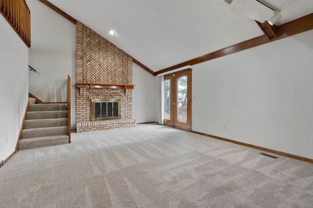 unfurnished living room featuring carpet floors, visible vents, a fireplace, and baseboards