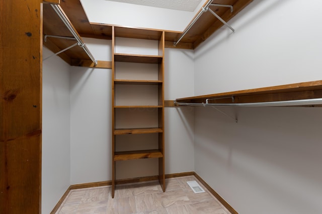 walk in closet with visible vents