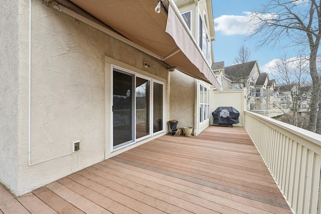 wooden terrace with a grill