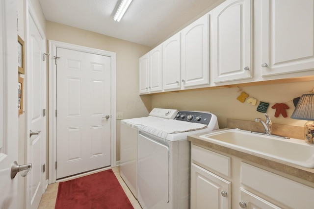 laundry room with washer and dryer, cabinet space, and a sink