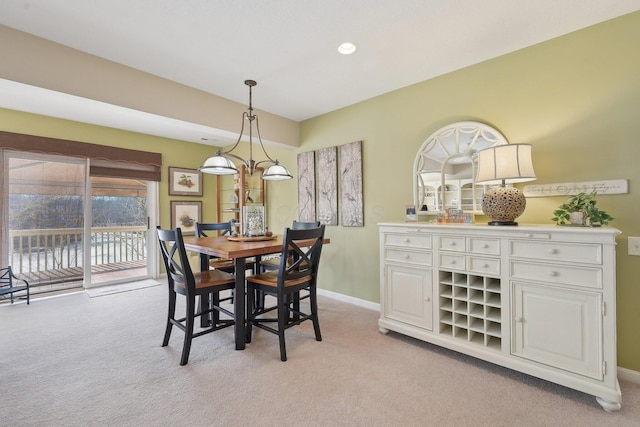 dining space featuring recessed lighting, light carpet, and baseboards