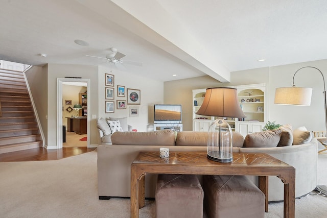 living room with light carpet, a ceiling fan, beamed ceiling, stairs, and recessed lighting