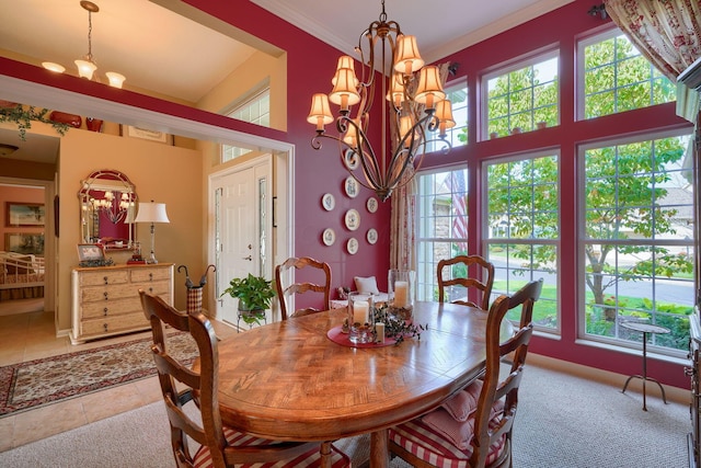 dining room with an inviting chandelier, crown molding, a high ceiling, and a wealth of natural light