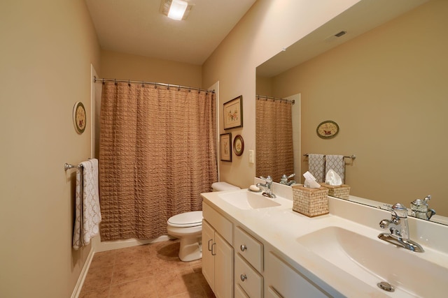 bathroom featuring visible vents, a sink, toilet, and double vanity