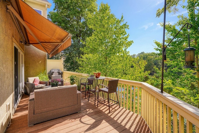 wooden deck with a grill