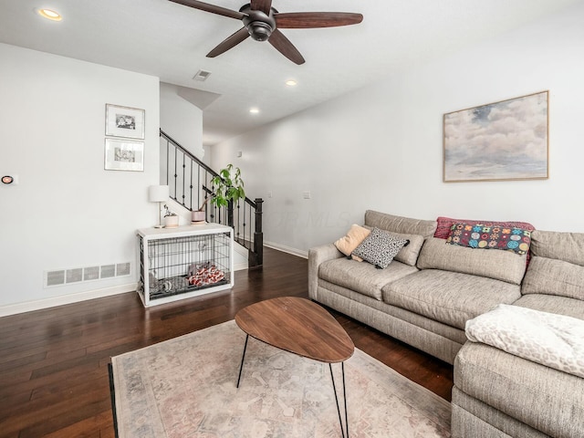 living room featuring stairway, dark wood finished floors, visible vents, and recessed lighting