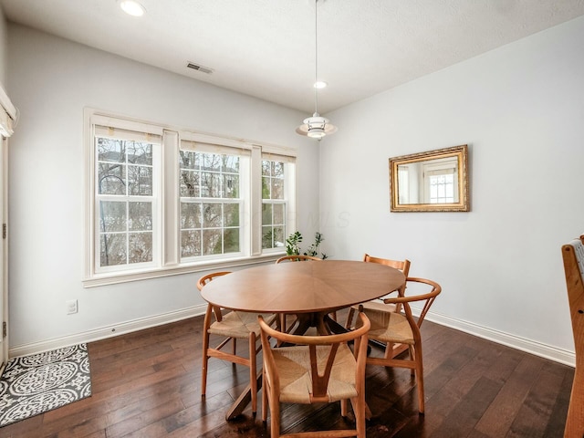 dining area with dark wood-type flooring, recessed lighting, and baseboards