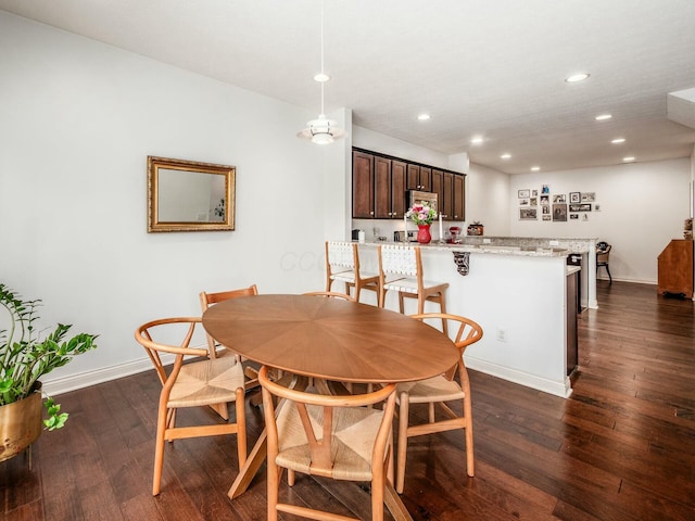 dining space featuring baseboards, dark wood-style flooring, and recessed lighting