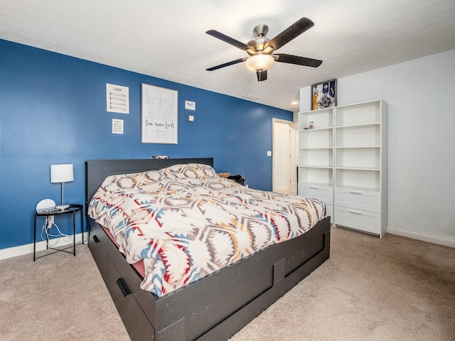 bedroom featuring carpet flooring, a ceiling fan, and baseboards